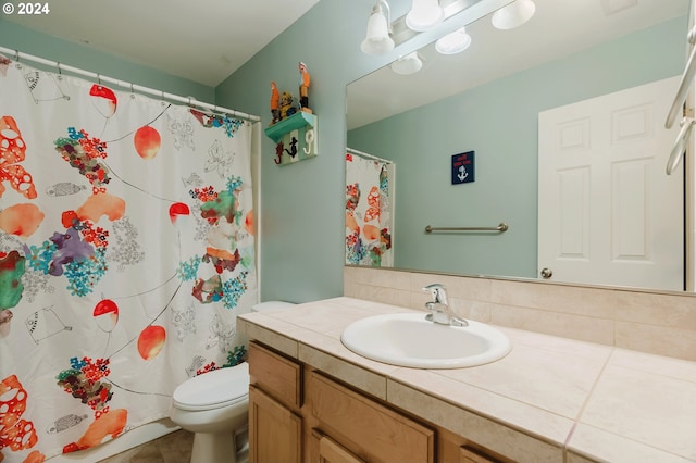 bathroom featuring tile patterned floors, vanity, and toilet