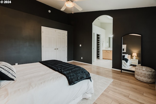 bedroom with connected bathroom, ceiling fan, a closet, and light wood-type flooring