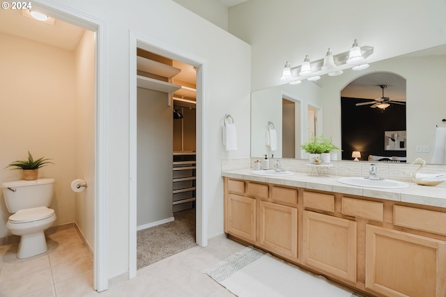 bathroom with tile patterned floors, ceiling fan, toilet, and vanity