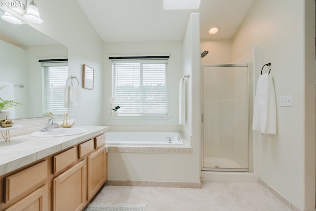 bathroom featuring tile patterned floors, vanity, and shower with separate bathtub