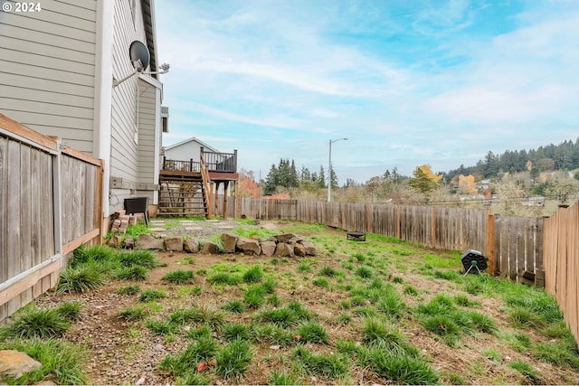 view of yard featuring a wooden deck