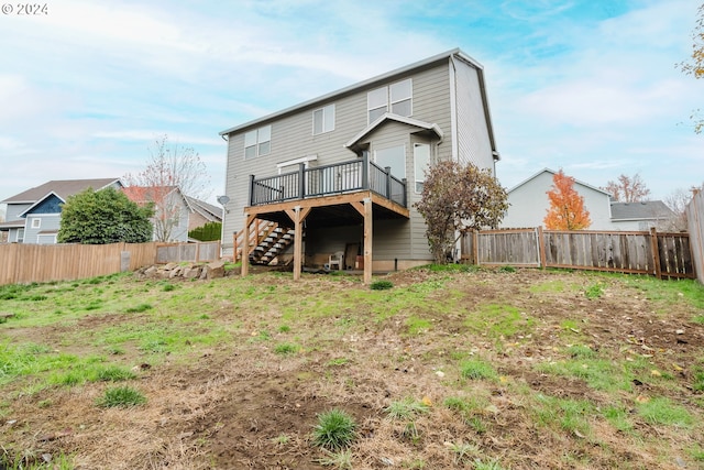 back of property featuring a wooden deck