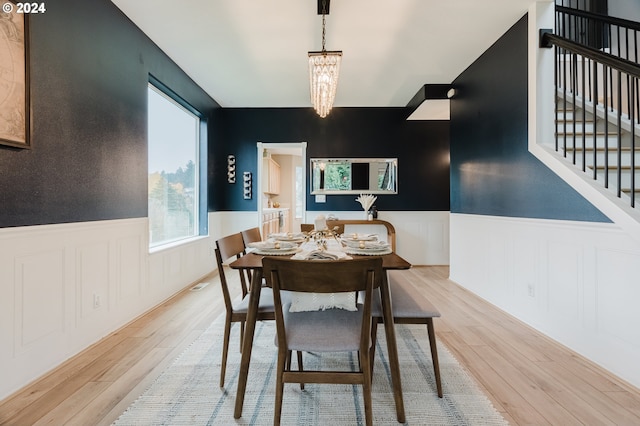 dining space featuring a chandelier and light hardwood / wood-style floors