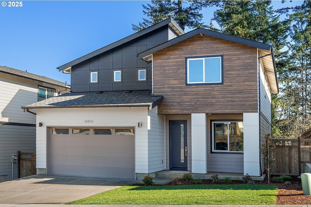 view of front of house with concrete driveway, fence, a garage, and a shingled roof
