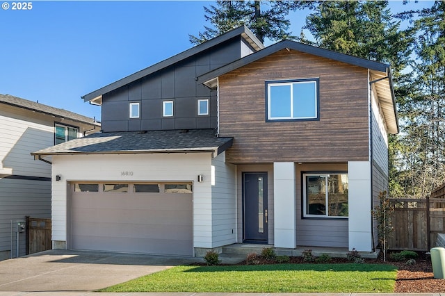 view of front of house with concrete driveway, fence, a garage, and a shingled roof