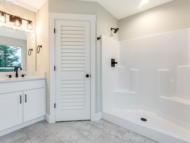 bathroom with a shower and vanity