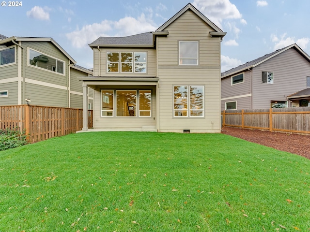 rear view of house with a lawn