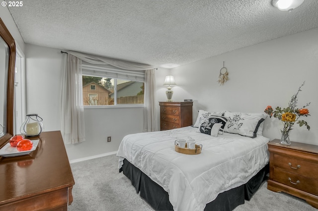 carpeted bedroom featuring a textured ceiling