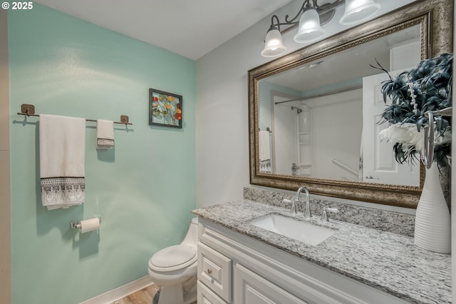 bathroom with vanity, hardwood / wood-style floors, toilet, and walk in shower