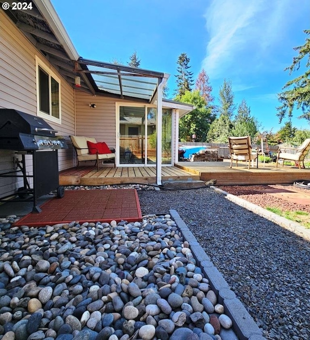 view of patio featuring a grill and a deck