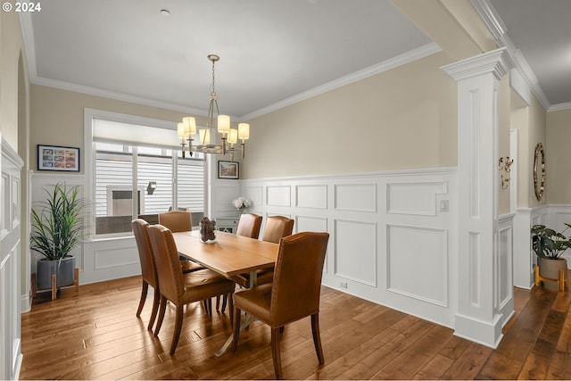 dining space featuring crown molding and hardwood / wood-style flooring