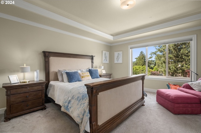 bedroom featuring carpet flooring, ornamental molding, and a raised ceiling