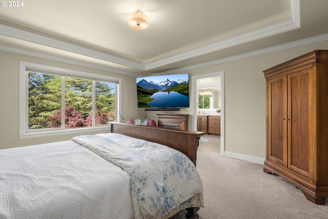 bedroom with ensuite bath, a raised ceiling, light carpet, and ornamental molding