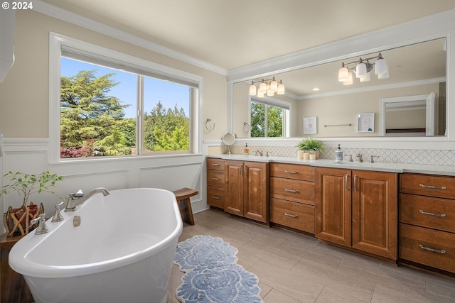 bathroom featuring tile patterned floors, ornamental molding, vanity, backsplash, and a bath