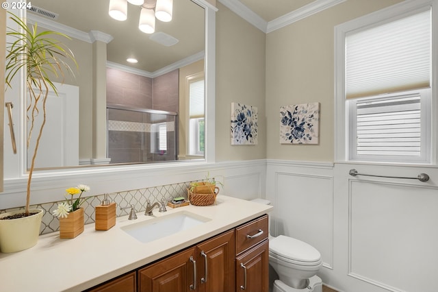 bathroom featuring toilet, an enclosed shower, crown molding, and vanity