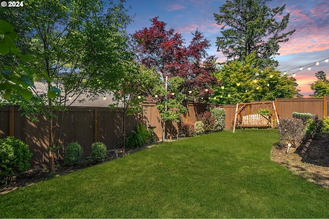 view of yard at dusk