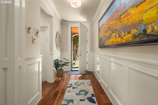 interior space with dark hardwood / wood-style floors and ornamental molding