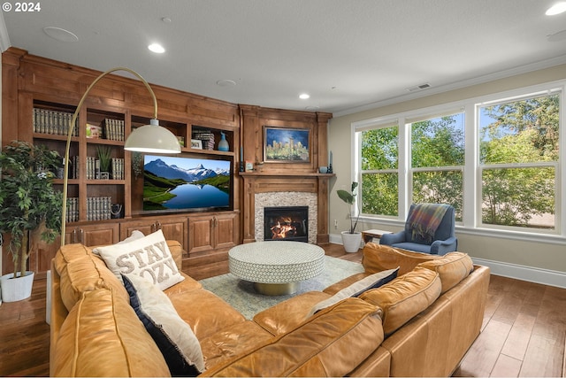 living room with ornamental molding and hardwood / wood-style flooring