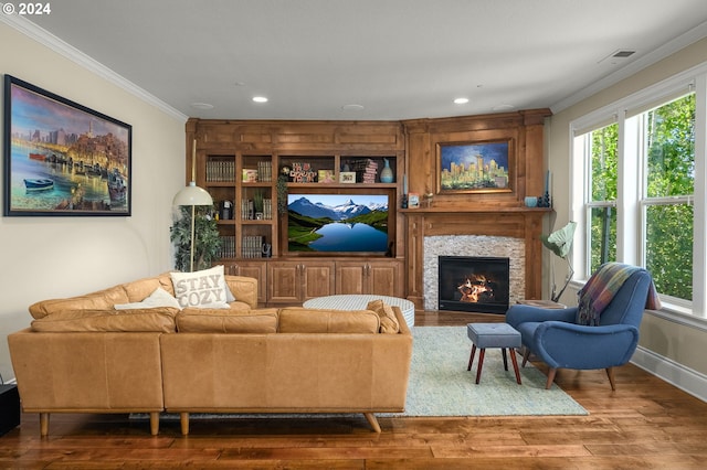 living room featuring a wealth of natural light, a fireplace, dark hardwood / wood-style floors, and crown molding