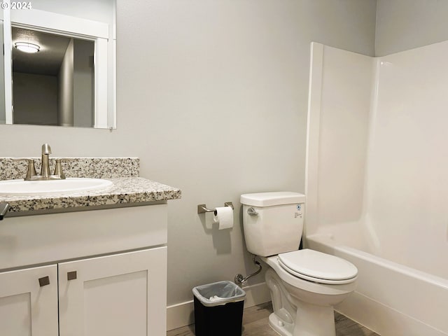 full bathroom with vanity, toilet, shower / washtub combination, and hardwood / wood-style floors