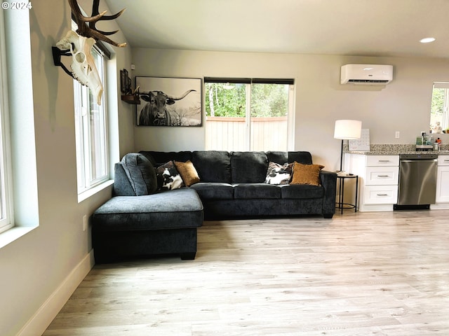 living room featuring light hardwood / wood-style flooring and a wall mounted AC