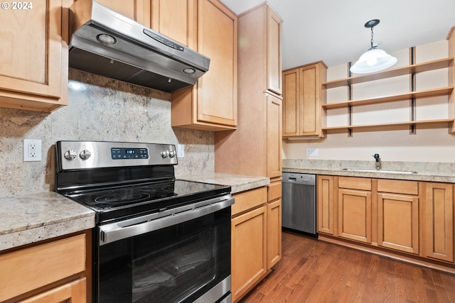 kitchen with backsplash, sink, hanging light fixtures, and appliances with stainless steel finishes