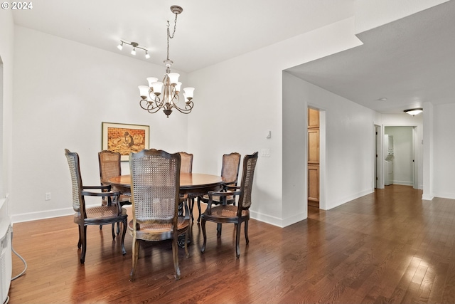 dining room featuring dark wood-type flooring and an inviting chandelier