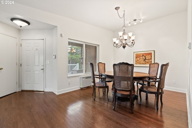 dining space with a notable chandelier, radiator heating unit, and dark wood-type flooring