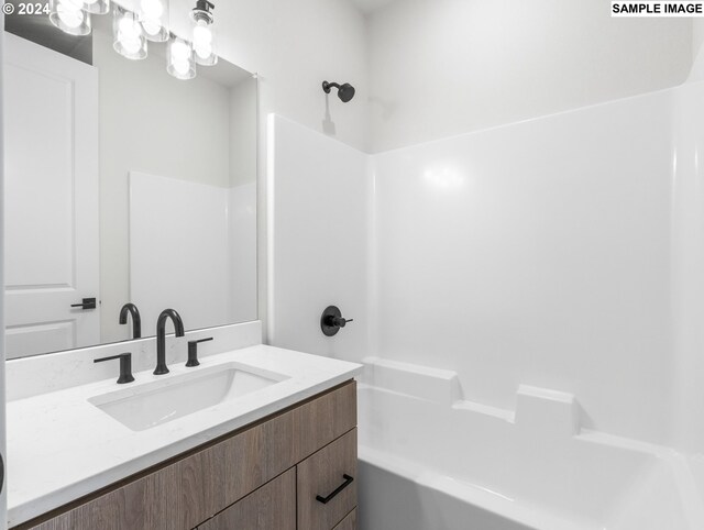 bathroom with shower / bathing tub combination and vanity