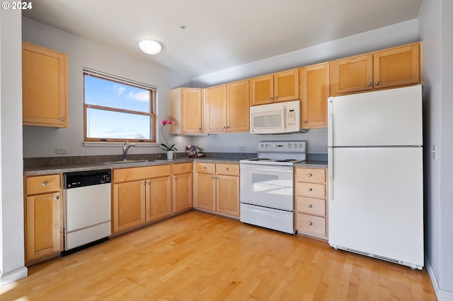 kitchen with light brown cabinets, sink, white appliances, and light wood-type flooring