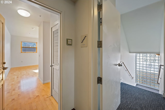 hallway with light hardwood / wood-style flooring