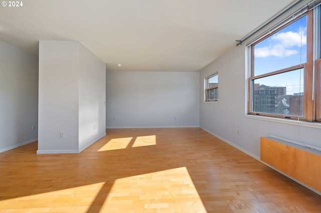 unfurnished room with plenty of natural light and light wood-type flooring