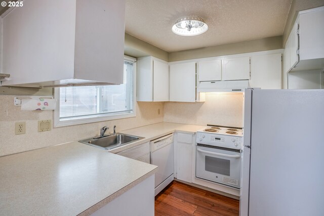 kitchen featuring dark hardwood / wood-style flooring, white appliances, an inviting chandelier, white cabinetry, and hanging light fixtures