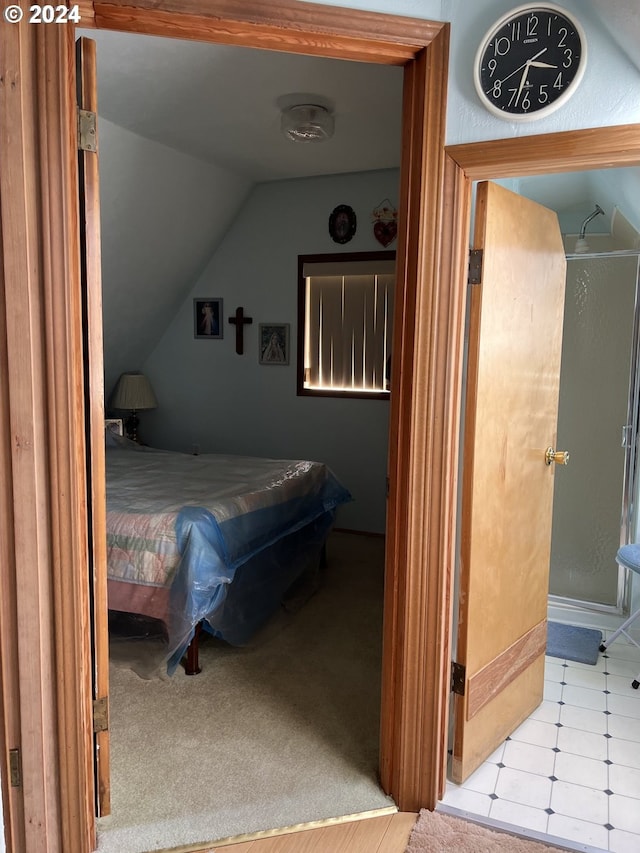 bedroom with lofted ceiling and light carpet