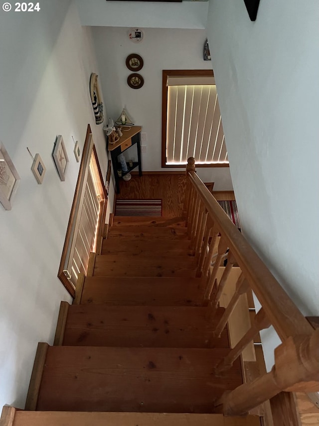 stairway featuring wood finished floors