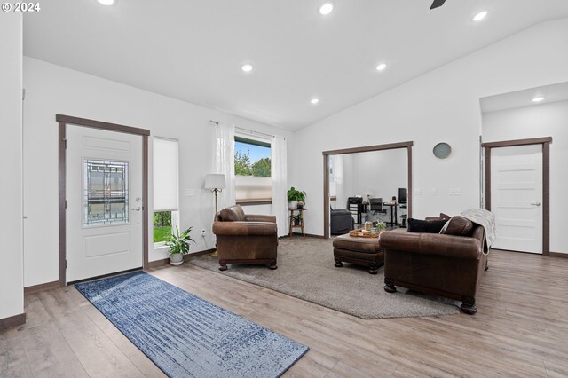 living room with lofted ceiling and light hardwood / wood-style flooring