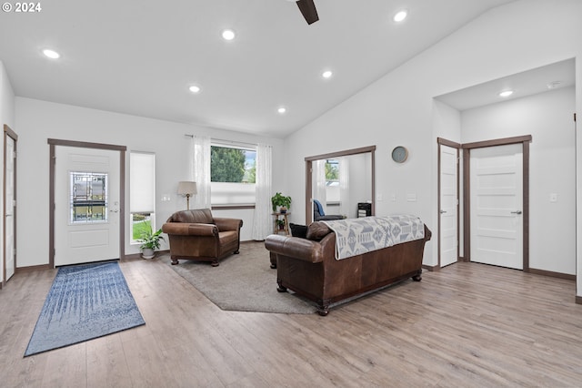 living room with vaulted ceiling, ceiling fan, and light hardwood / wood-style floors