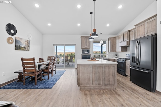 kitchen featuring hanging light fixtures, vaulted ceiling, black gas range oven, a kitchen island, and stainless steel fridge with ice dispenser