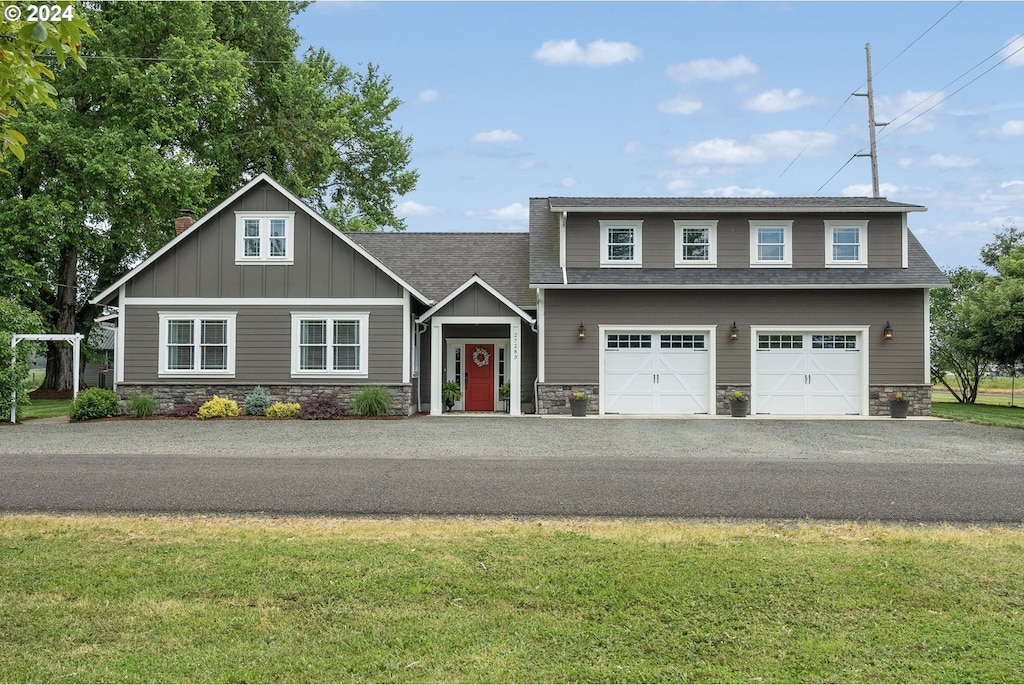 view of front of property with a garage and a front lawn