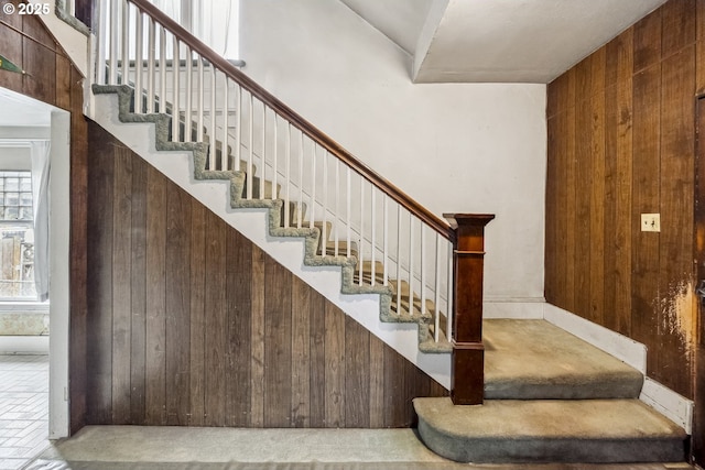 staircase with wood walls