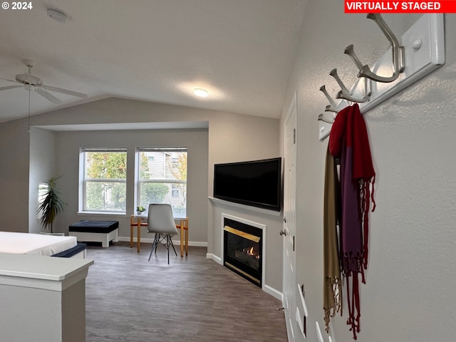 interior space with lofted ceiling, hardwood / wood-style floors, and ceiling fan