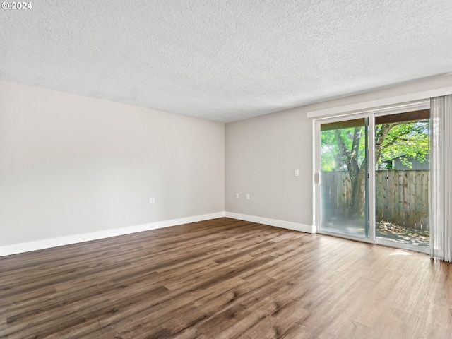 unfurnished room featuring a textured ceiling and hardwood / wood-style flooring