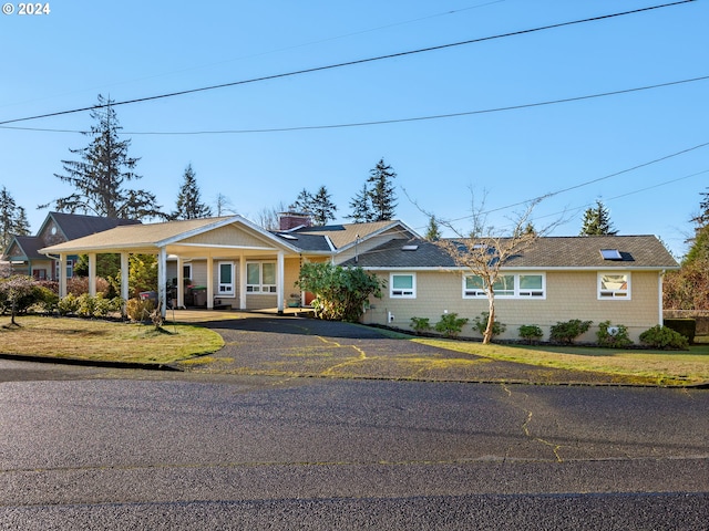 single story home with a porch and a front lawn