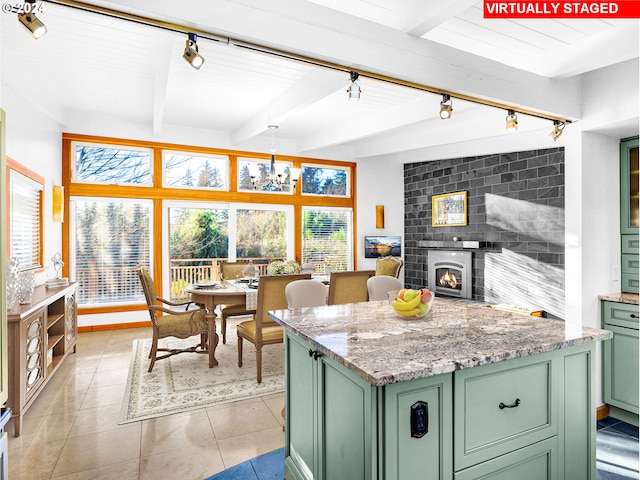 kitchen featuring beam ceiling, rail lighting, and green cabinetry