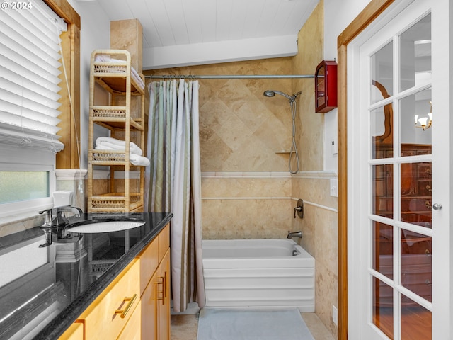 bathroom with vaulted ceiling, vanity, and shower / bath combo