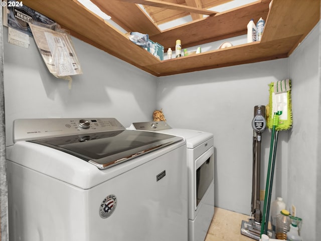 clothes washing area featuring separate washer and dryer