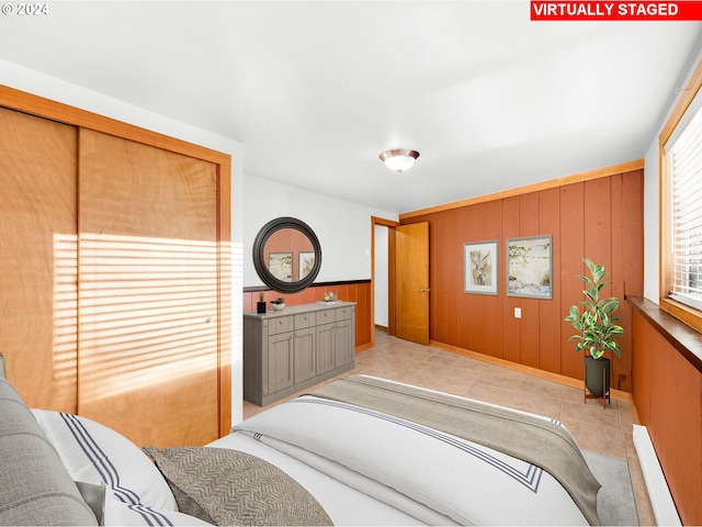 tiled bedroom with wooden walls and a baseboard radiator