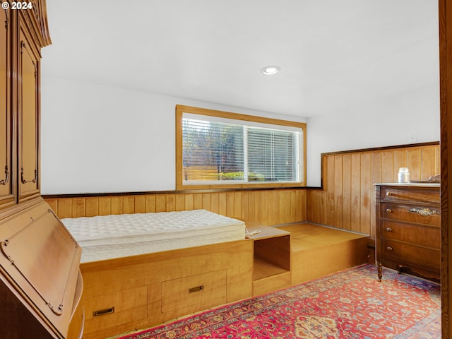 bedroom with wooden walls