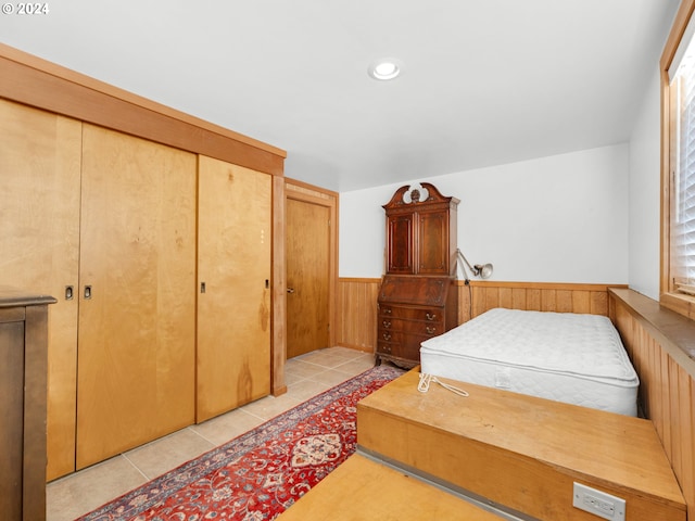 bedroom featuring a closet and light tile patterned floors