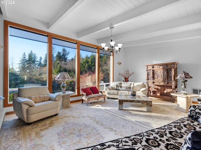 living room featuring beamed ceiling, a healthy amount of sunlight, and an inviting chandelier